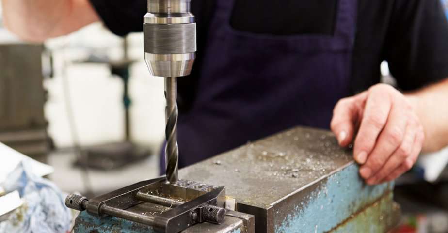 black oxide drill bit being used to cut through steel