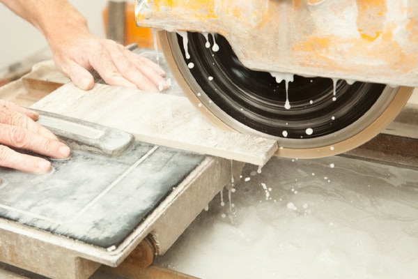 Worker Cutting Porcelain Tile with Circular Saw