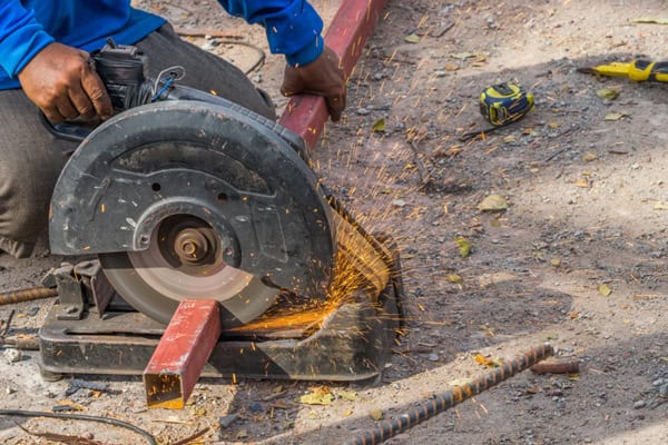 Worker Using Out-Off Wheel on Metal Worker Using Out-Off Wheel on Metal